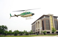 Image of a helicopter flying by a building