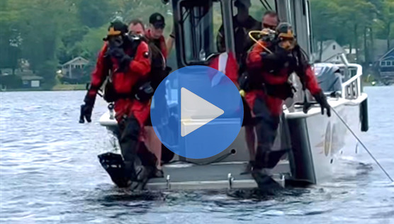 Dive team jumping off the boat
