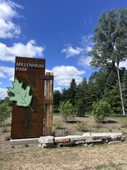 Millennium Park's New Entryway Sign Can Be Sign Towering Above the Butterworth and Maynard Intersection Against a Baby Blue Sky