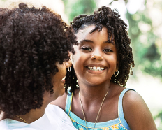 African American mother and daughter smiling