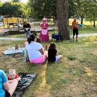 Reading books to families in the park
