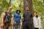 Image of volunteers surround by trees
