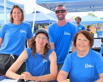 Image of four Kent County employees wearing matchin blue shirts