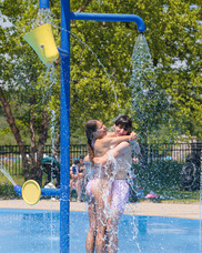 Couple Embraces While Standing Under a Water Feature at Millennium Park's Splashpad