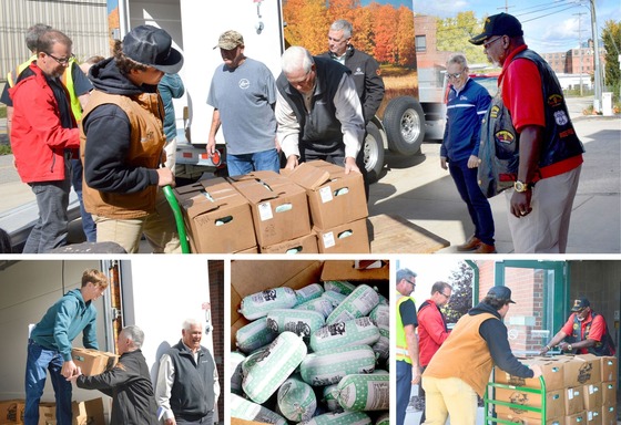 Image of men unloading venison boxes from a truck