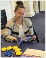 Yesenia Ceja-Ramirez, Northeast Region Student Services supervisor, prepares for a recent Washburn University Practicum and Internship fair.   