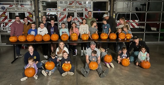 Children of Fire/EMS staff pose with their carved pumpkins