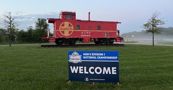 NJCAA sign in front of caboose at Sand Creek Station
