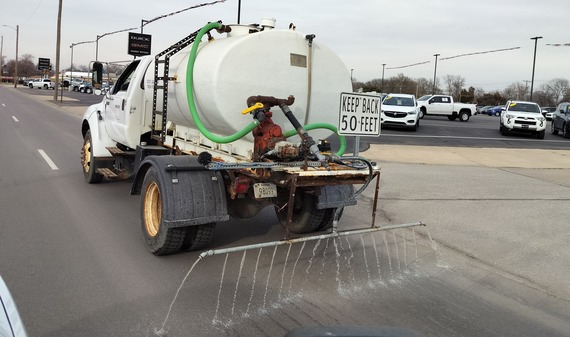 Truck spraying pre-treatment on road 1-4-24