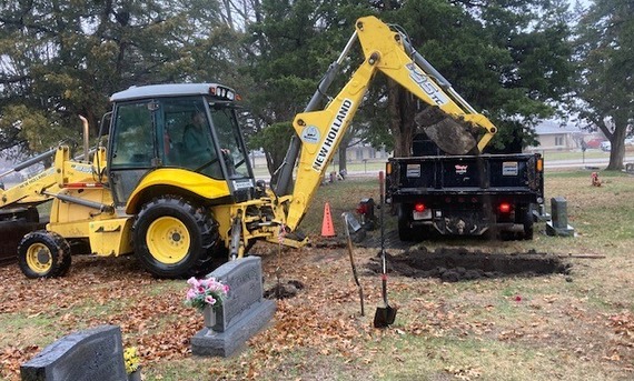 Staff prepares a grave at cemetery