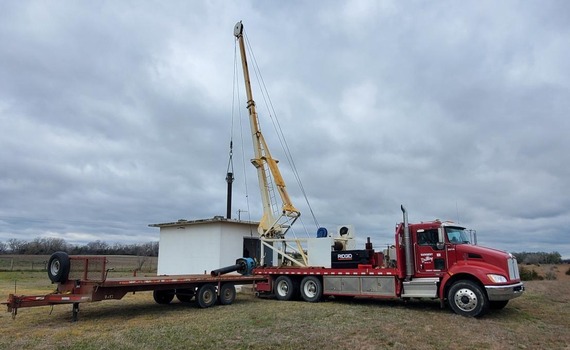 Water well being rehabbed with semi truck in foreground