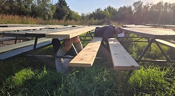Parks staff repairing picnic tables