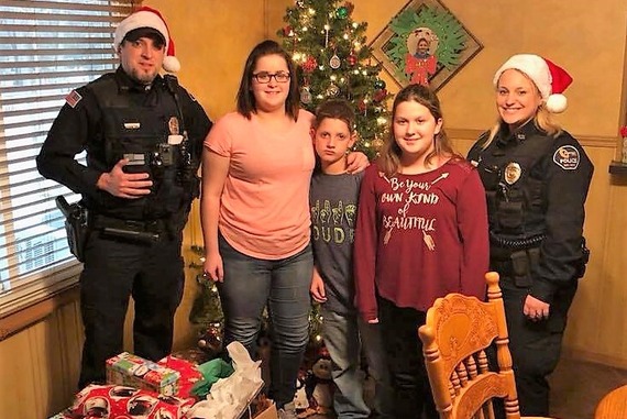 Newton officers delivering Christmas gifts to a family in 2017