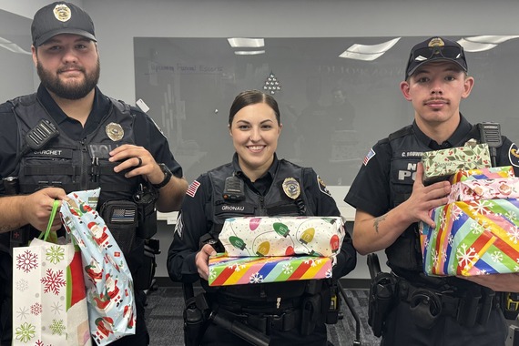 Officers holding Blue Christmas gifts