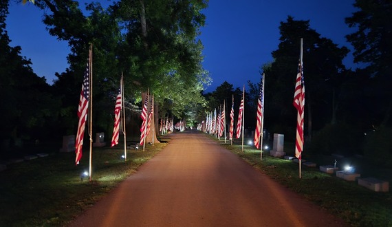 Memorial Day flags at cemetery at night