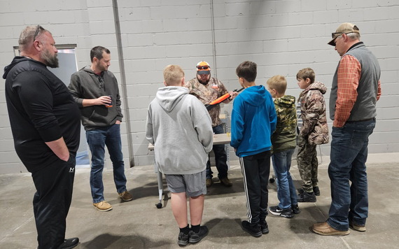 Officer going over gun safety with students in the hunter education class