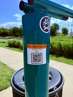 Need to report an issue sticker on bike repair stations around Newton.