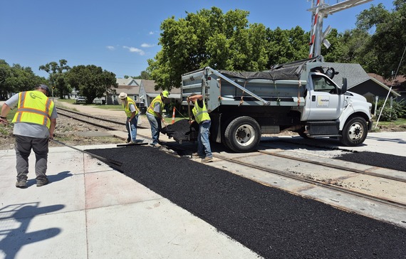City crews applying final asphalt at First and Kansas rail crossing
