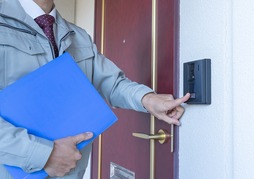 Salesman ringing doorbell