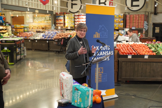 Governor Kelly speaks during an 'Axing Your Taxes' event at a grocery store