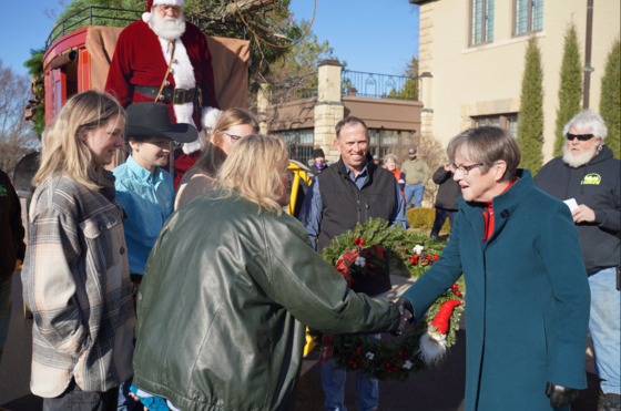 Governor Kelly receives the annual Christmas tree at Cedar Crest mansion