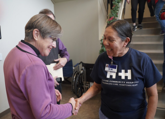 Governor Kelly with a healthcare worker in Holton