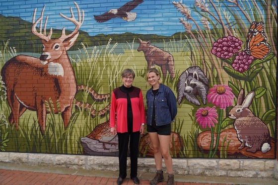 Governor Kelly with a rural mural and artist