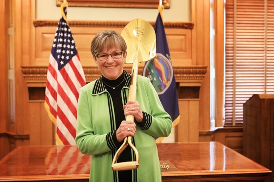 Governor Kelly with the Gold Shovel Award Kansas has won for four consecutive years for economic success