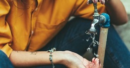 Hands through running water photo 