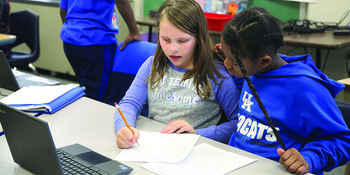 Two students at King Elementary School (Jefferson County), part of a group of gifted and talented students, collaborate on a project.