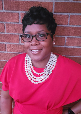 Picture of a smiling woman wearing glasses.