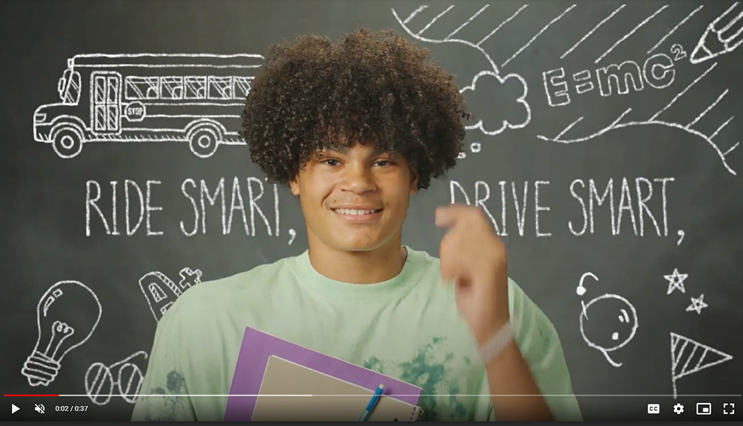 Screen shot of a young man in a school bus safety video.