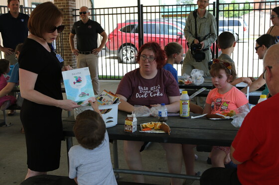 A student gets a book during the Summer Boost program event in Bullitt County in June of 2022.
