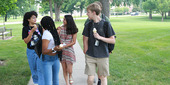 High school, students Janelle Pitmon, Kadi’ah Malone, Anya Sharma, Brayden Warren and Gillam Nicodemus walk along a sidewalk.