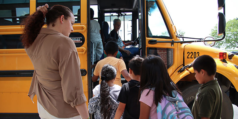 Students loading onto a bus/