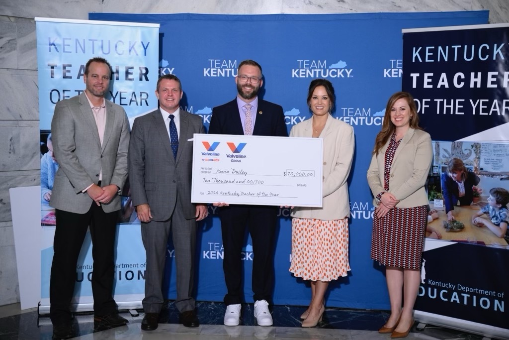 A picture of Kevin Dailey holding a large fake check, with Jon Caldwell, Jason Glass, Lt. Gov. Jacqueline Coleman and Laura Pentova.