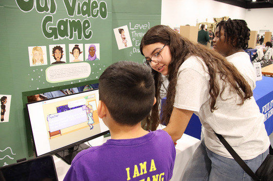 Students show another student a game they developed