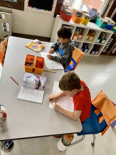 Two students working at table