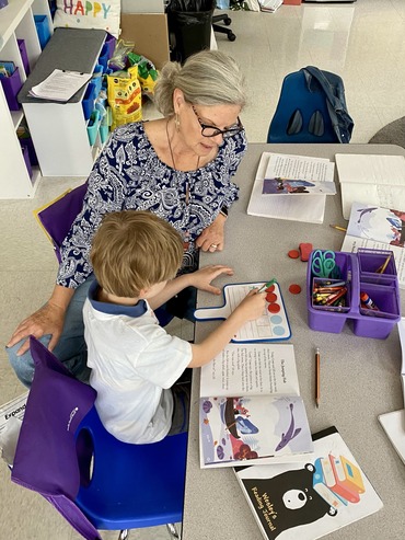 Teacher working with student on whitebord