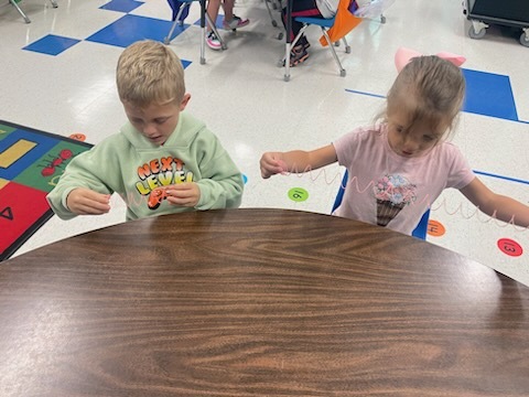 Students holding slinkies