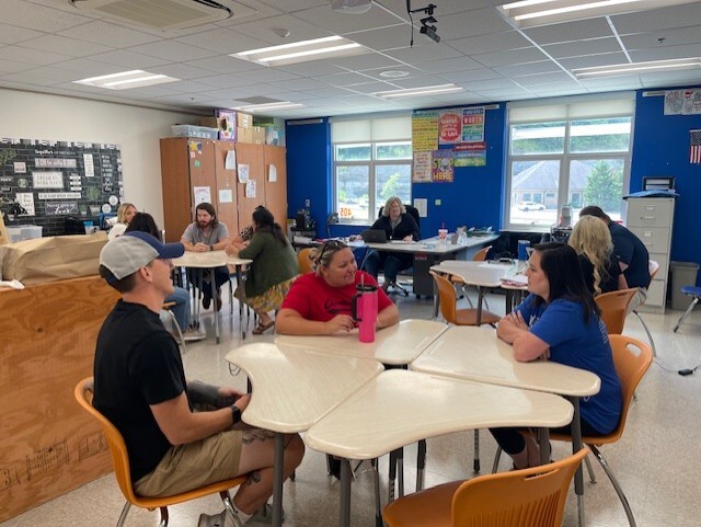 Tables of teachers talking