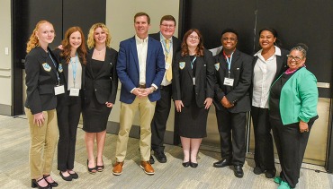 A picture of students surrounding Kentucky Gov. Andy Beashear.