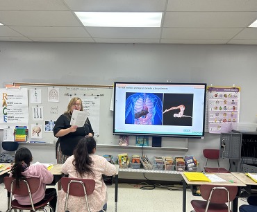 Teacher at front of room
