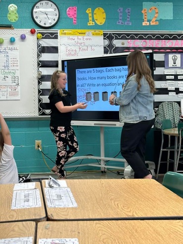 Student and teacher at interactive board 