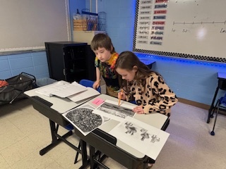 Two students reviewing artifacts
