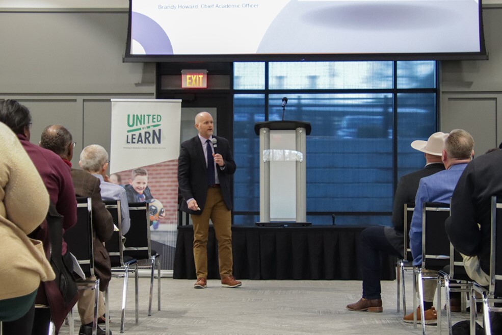 Jesse Bacon of Bulliet County schools stands in front of a crowd during a town hall meeting addressing attendees