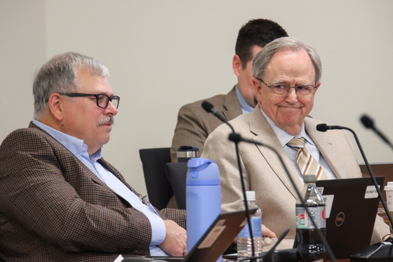 Two Kentucky Board of Education members sitting at a table 