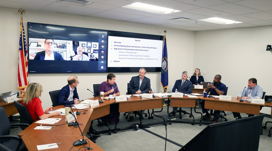 Group of individuals at a large round table.