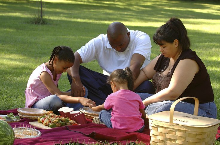 multiracial family praying