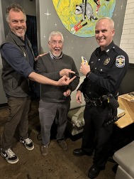 Ben and constituents holding gift cards for the LMPD Fitbit Challenge 